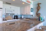 Coastal vibe kitchen includes granite countertops